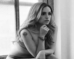 She has a tattoo on her wrist and shoulder.